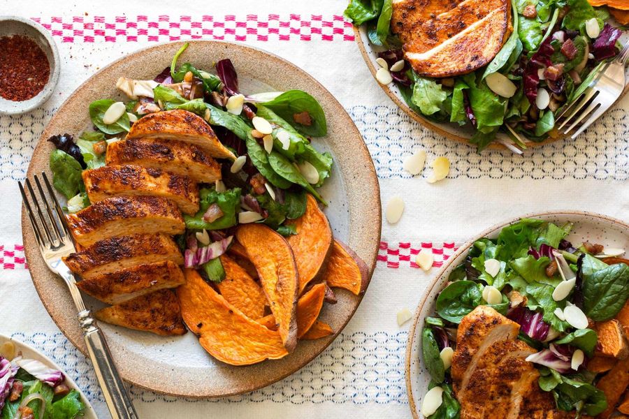 Paprika-spiced chicken with spinach salad and sweet potato fries