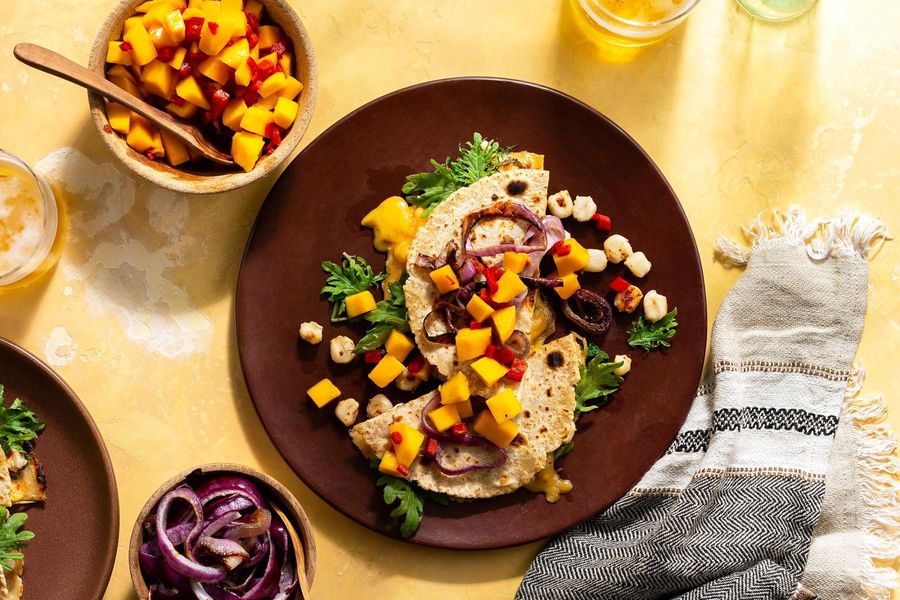 Hominy and kale quesadillas with mango salsa and caramelized onions