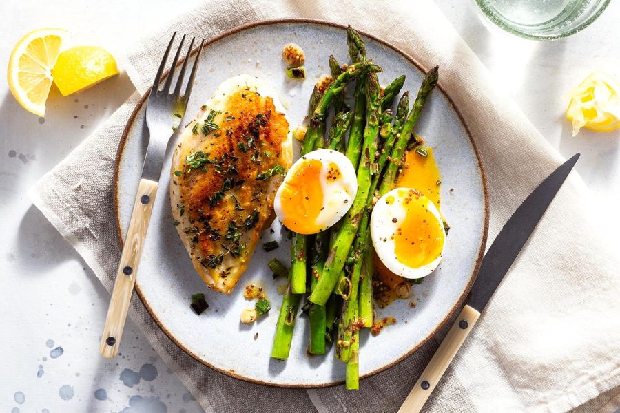 Herbed chicken with sautéed asparagus and soft-cooked eggs