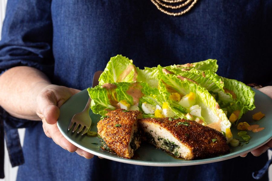 Chicken Kiev and Russian salad with hard-cooked eggs and scallions