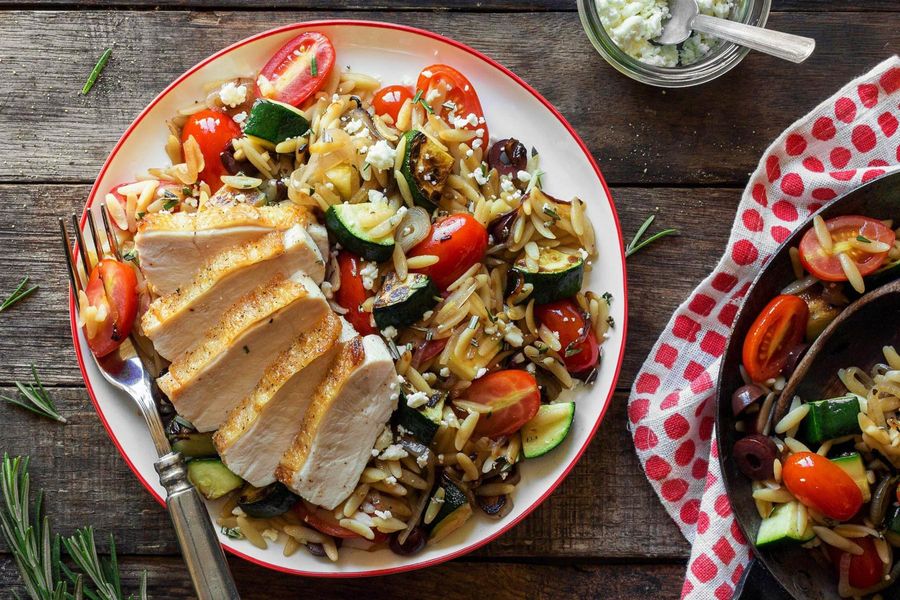 Chicken breasts with cherry tomatoes, summer squash, and olives