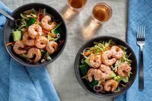 Spicy shrimp over smashed cucumber salad