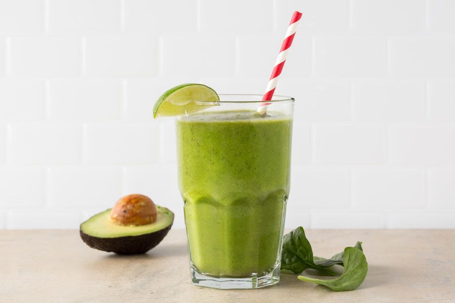 Image of Stress-Beater Smoothie, half an avocado, and a handful of spinach leaves