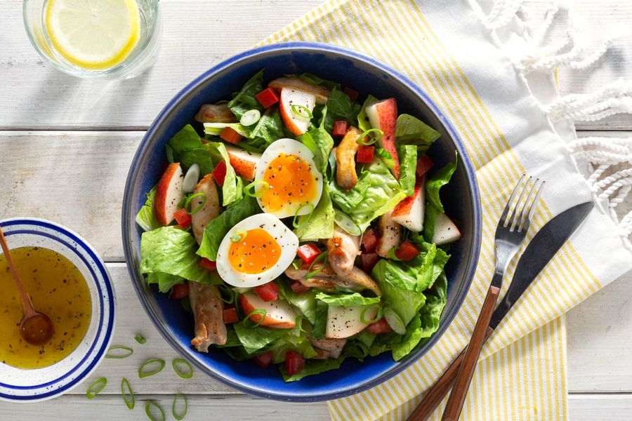 Green salad with chicken, pear, and soft-cooked eggs