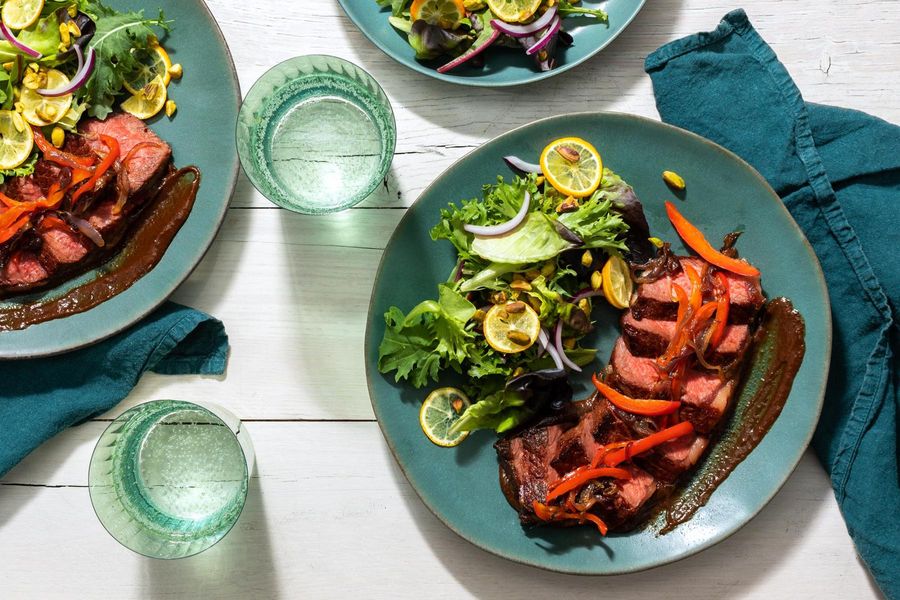 Pepper and onion–smothered Black Angus steaks with kumquat salad