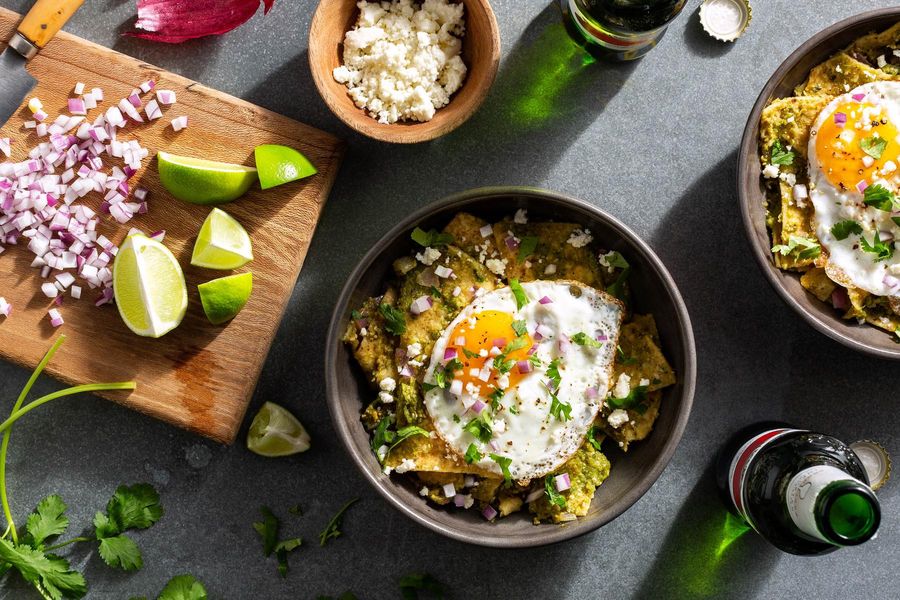 Chilaquiles verdes with fried eggs and queso fresco