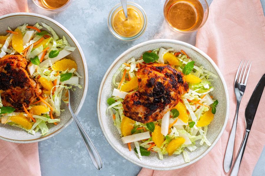 Spicy red curry chicken over warm jicama-citrus salad