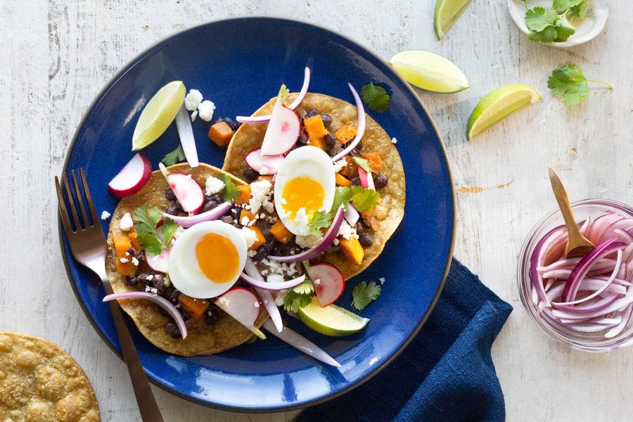 Black bean tostadas with squash, pickled onion, and soft-cooked eggs