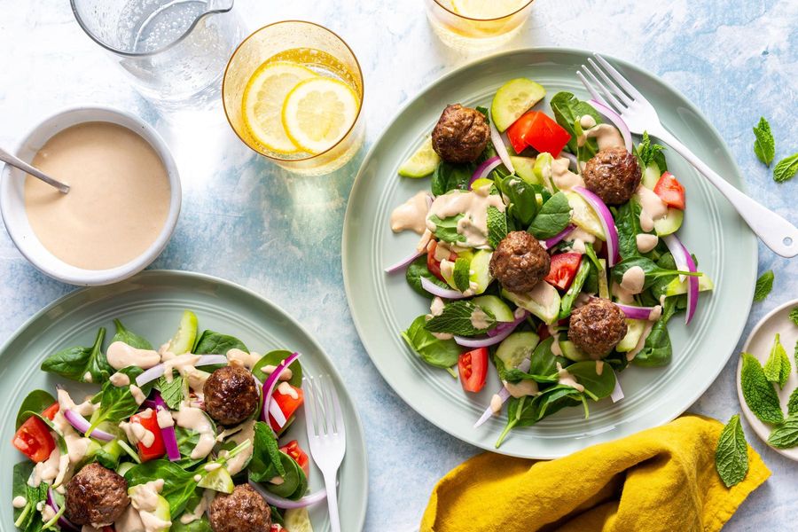 Greek meatballs with tomato-cucumber salad and lemon-tahini dressing