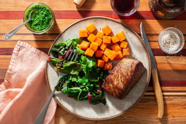 Steaks with chimichurri and harissa-roasted sweet potatoes