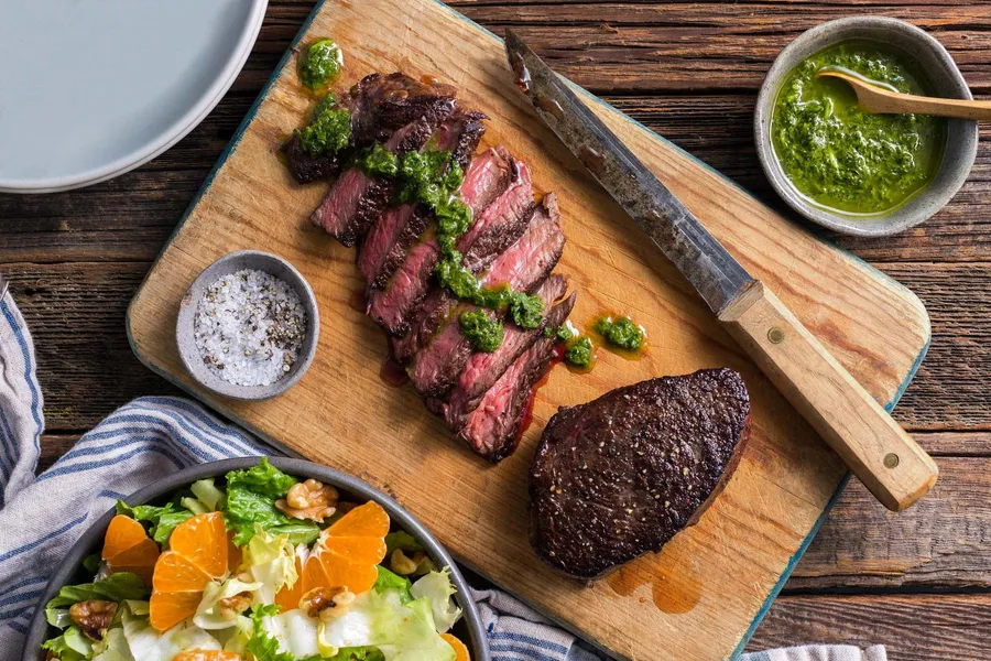 Pan-seared steaks with chimichurri and citrus-walnut salad Also available with top sirloin, rib-eyes, or filet mignon