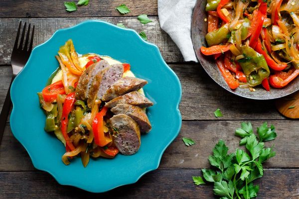 Pan-seared sausages with sweet peppers and polenta