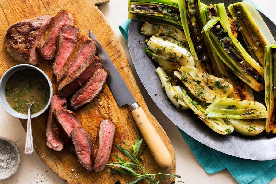 Steaks with braised leeks and warm caper-tarragon vinaigrette