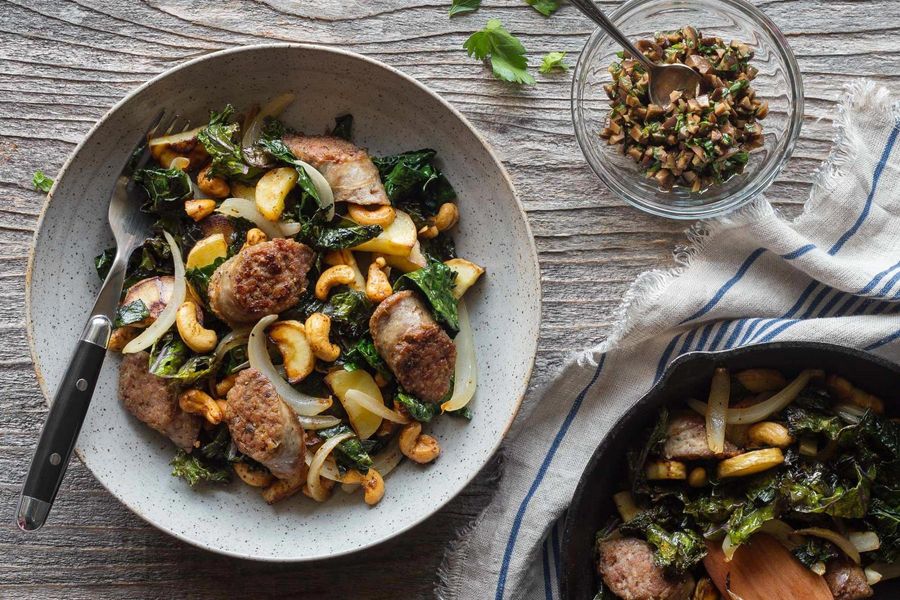 Italian sausages with kale, parsnips, and harissa-spiced cashews