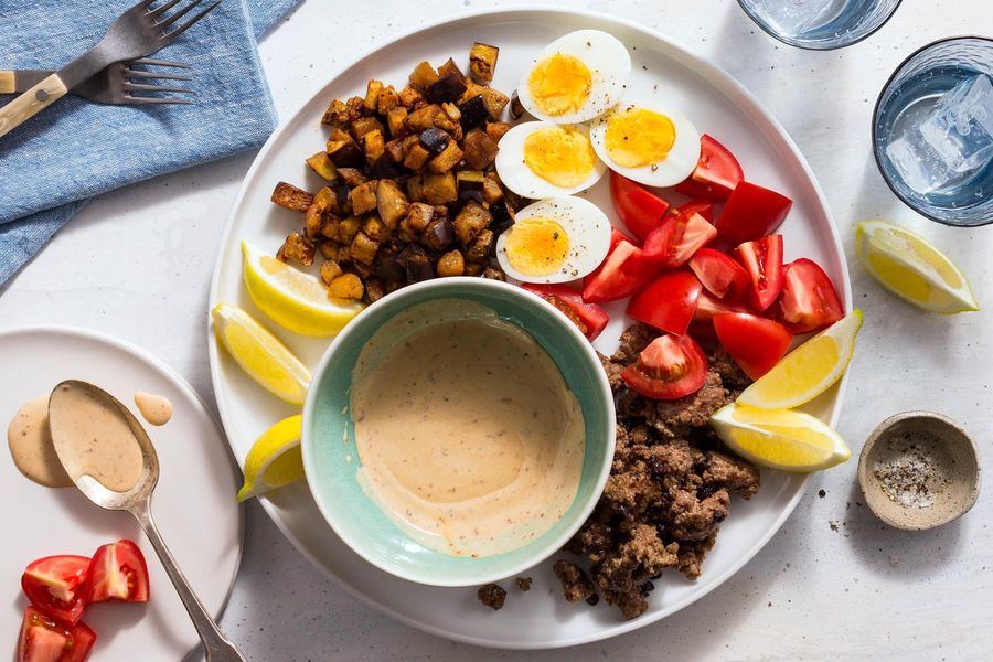Mediterranean meze platter with lamb, eggplant, and hard-cooked eggs