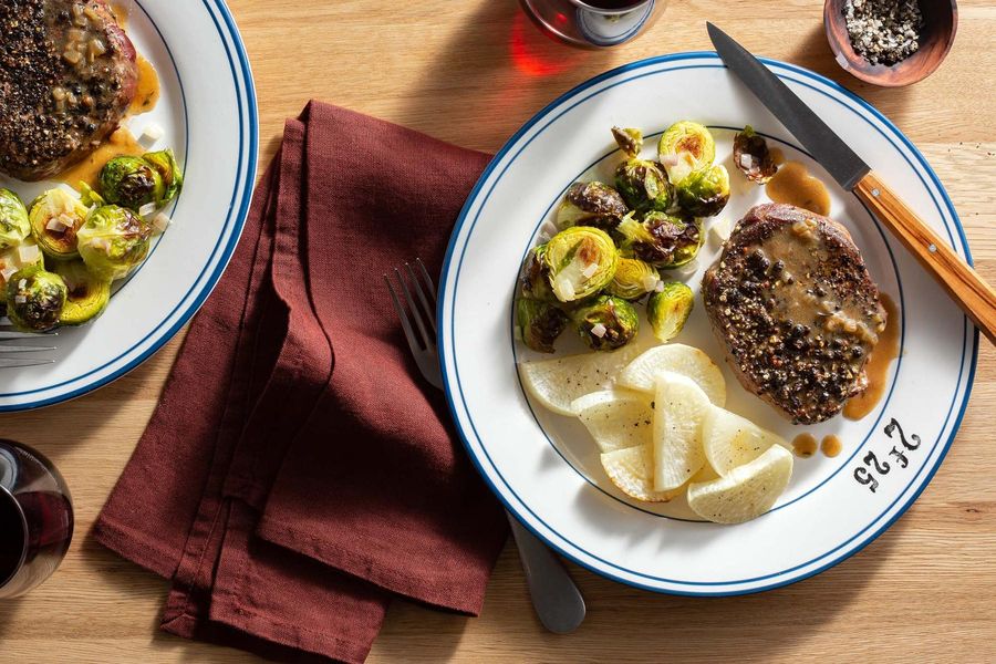 Rib-eye steaks au poivre with roasted vegetables