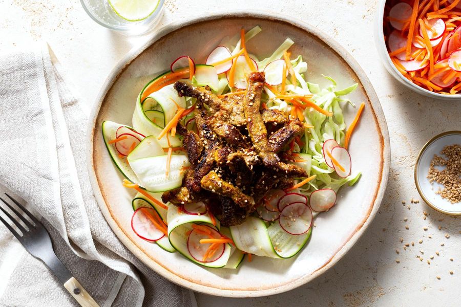 Lemongrass beef over “zoodles” with pickled radishes and carrots