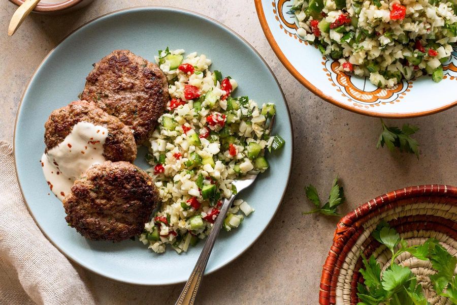 Spiced lamb patties with cauliflower tabbouleh and tahini dressing