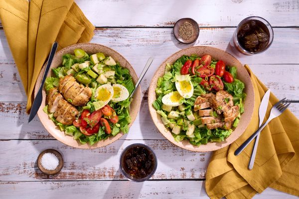Green salad with chicken, pear, and soft-cooked eggs
