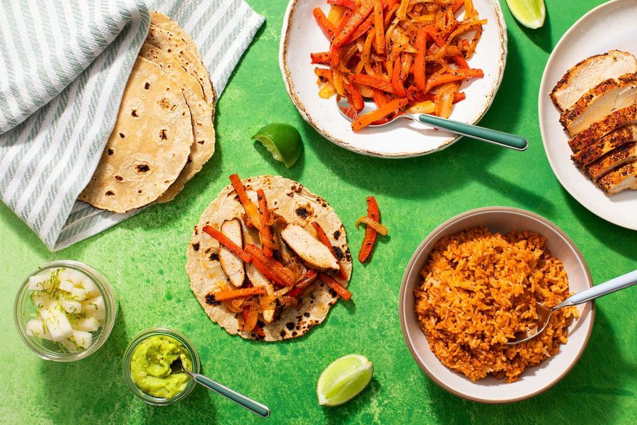 Chicken fajitas with chipotle rice, jicama sticks, and guacamole