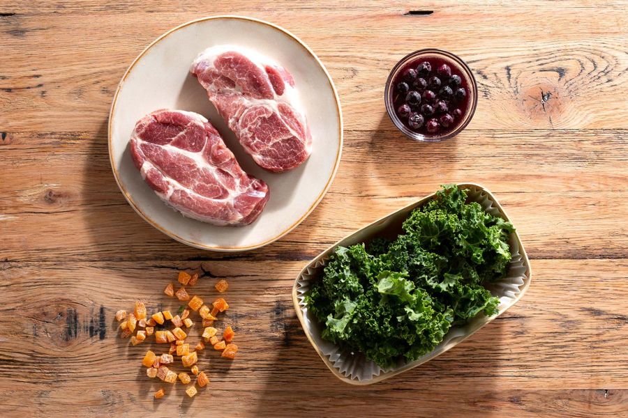 Pork blade steaks with blueberry-apricot sauce and sautéed kale