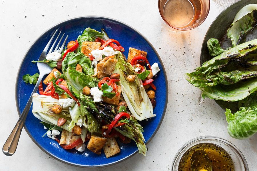 Charred romaine salad with spiced chickpeas, piquillo peppers, and almonds