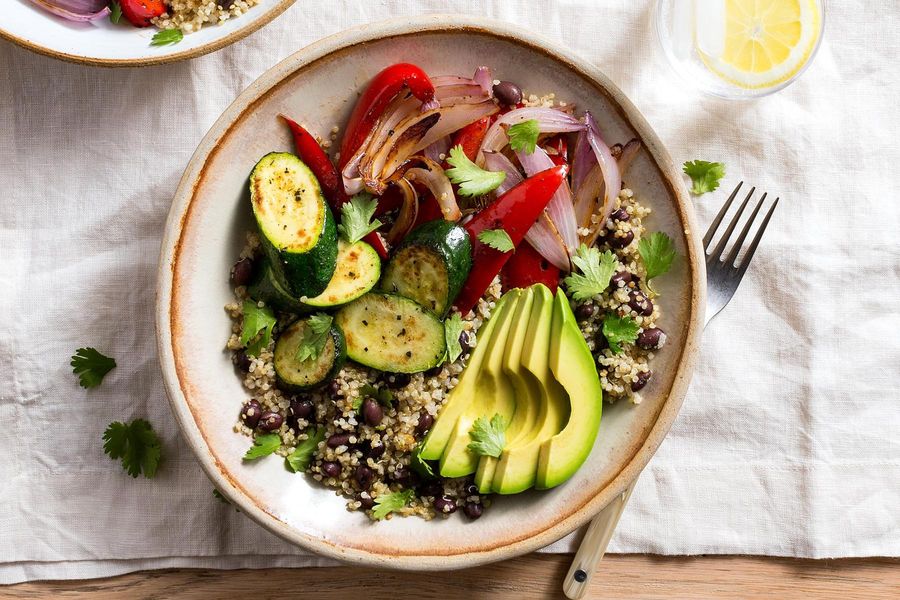 Black bean and quinoa burrito bowls with mixed vegetables and avocado