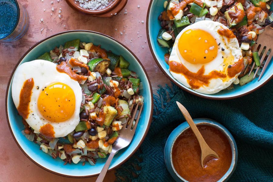 Mexican red rice with black beans, corn, and fried eggs
