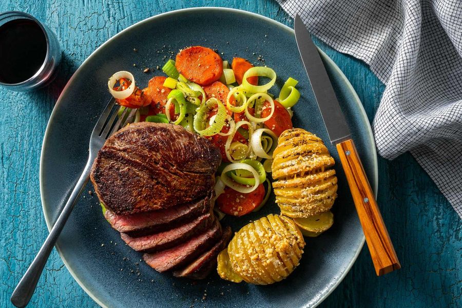 Sweet and spicy steaks with Hasselback potatoes and braised leek