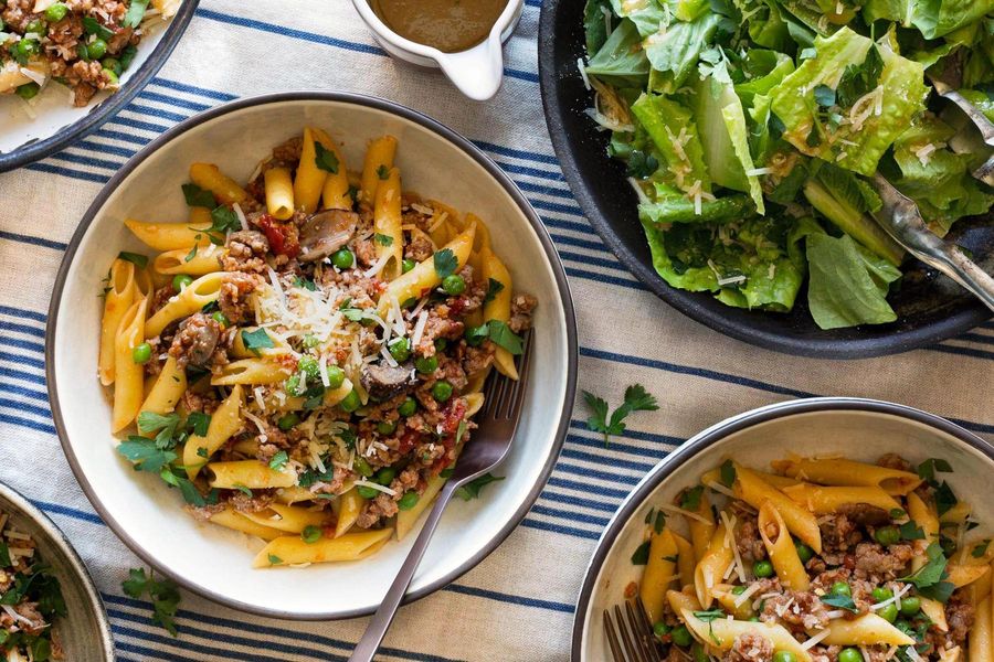 Italian sausage ragù with gluten-free penne and peas