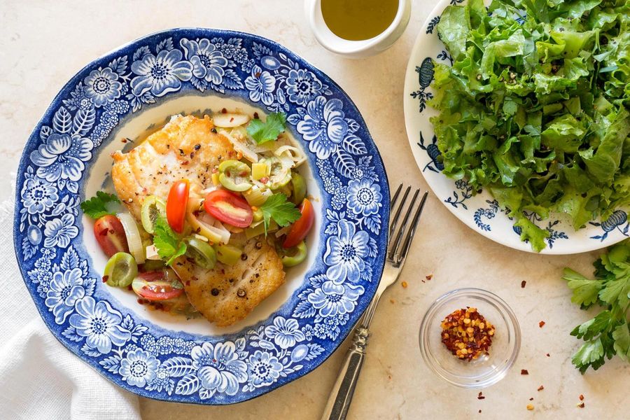 Braised cod and vegetables over smashed white beans