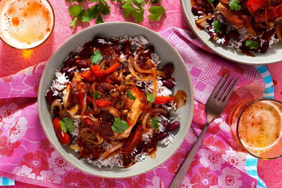 Belizean stewed chicken over coconut rice and beans