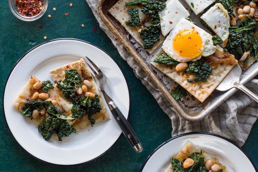 Flatbreads with fried eggs and kale-white bean salad