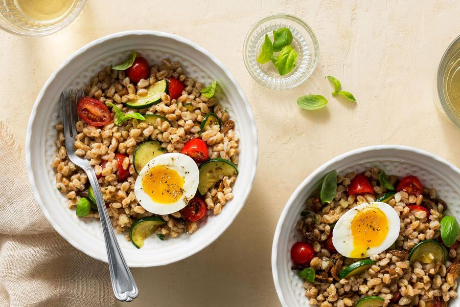 Farro risotto with zucchini, tomatoes, and soft-cooked eggs