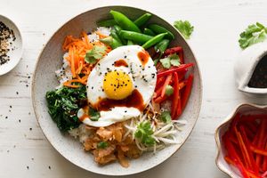 Bibimbap with snap peas, carrots, and fried eggs