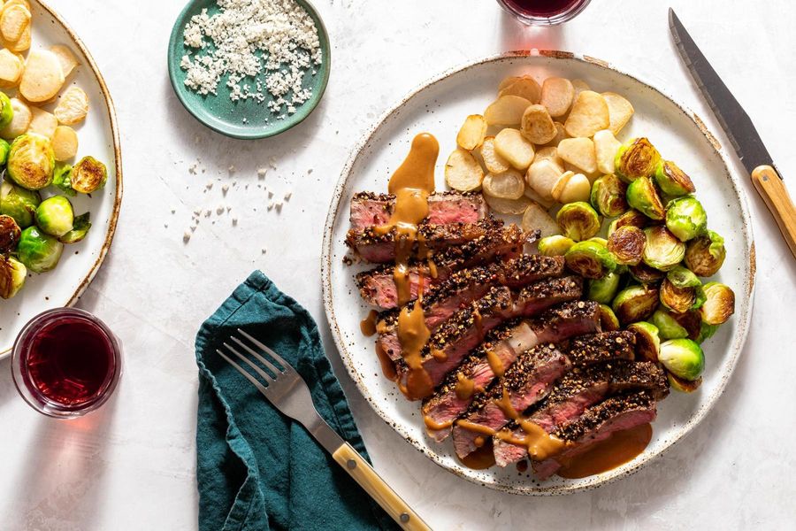Black Angus steaks au poivre with roasted vegetables