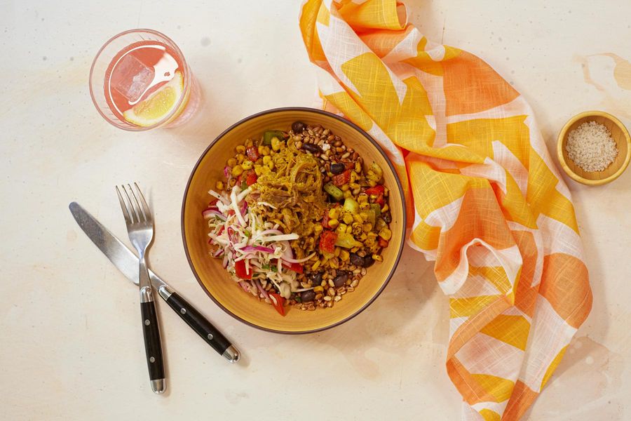 Spicy pulled pork grain bowl with sweet corn and bell pepper relish