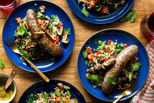 Italian sausages with warm cauliflower-kale salad and artichoke romesco