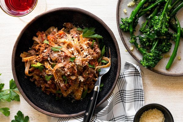 Fast fettuccine Bolognese with garlic-sautéed baby broccoli