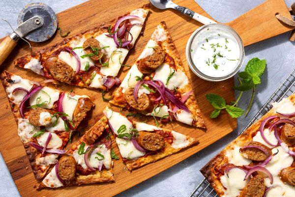 Spicy sausage flatbreads with harissa, mozzarella, and garlic yogurt