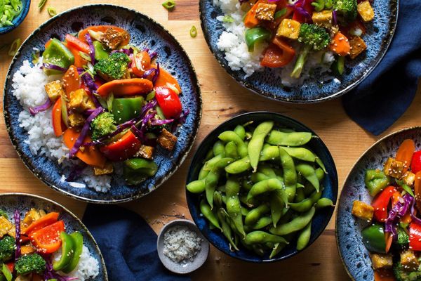 Orange-glazed tofu with bell peppers, broccoli, and jasmine rice