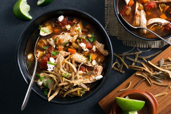 Chicken tortilla soup with queso fresco and lime