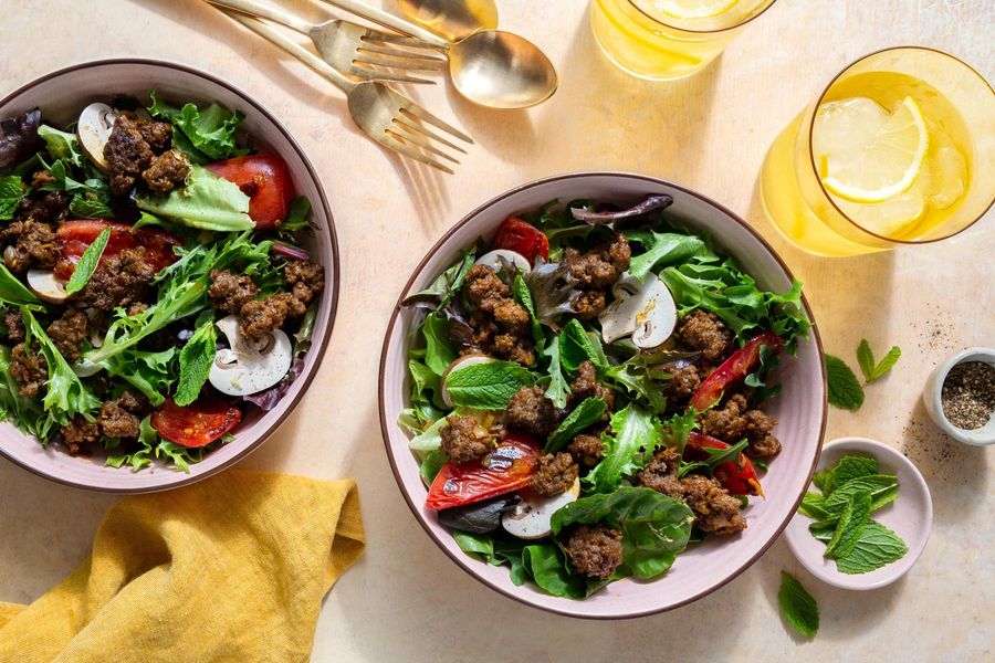 Larb salad with mushrooms, tomatoes, and fresh mint