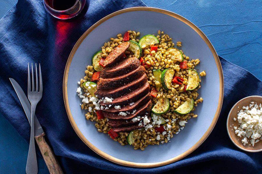 Spanish-spiced steaks with farro–red pepper salad and queso fresco