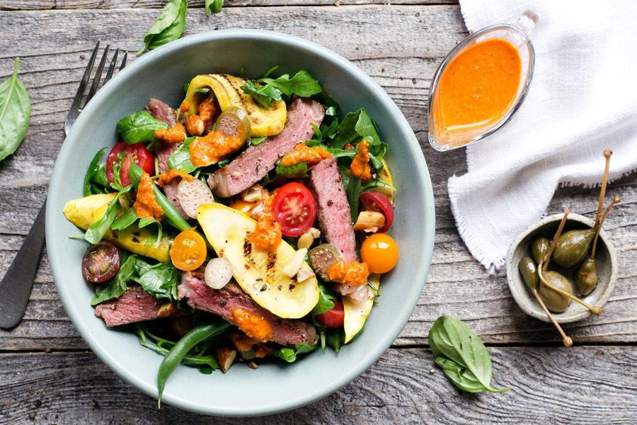 Steak salad with summer vegetables and romesco vinaigrette