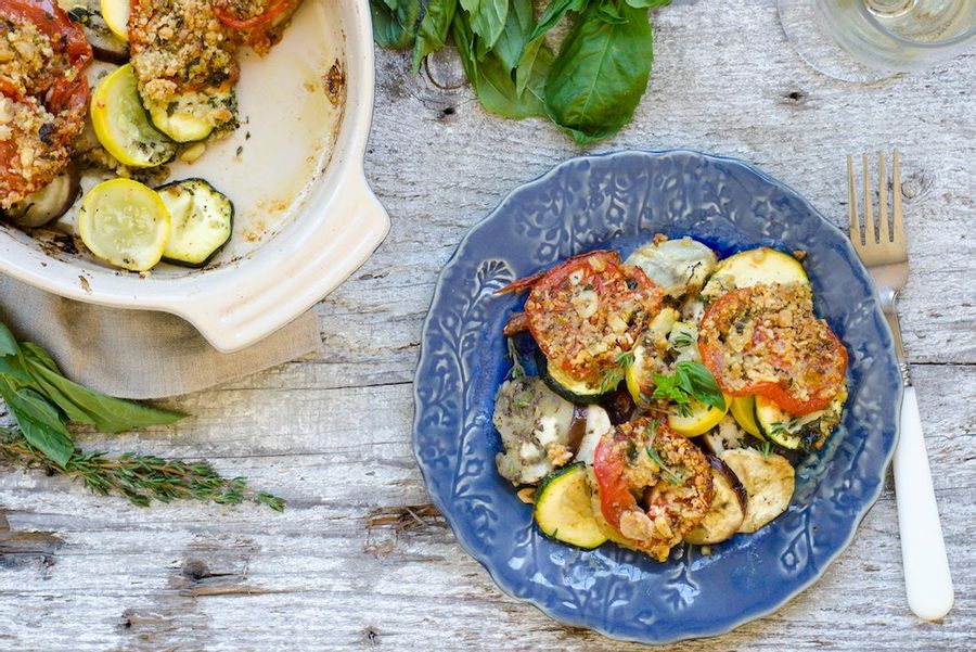 Summer vegetable gratin with pine nuts and fresh herbs 