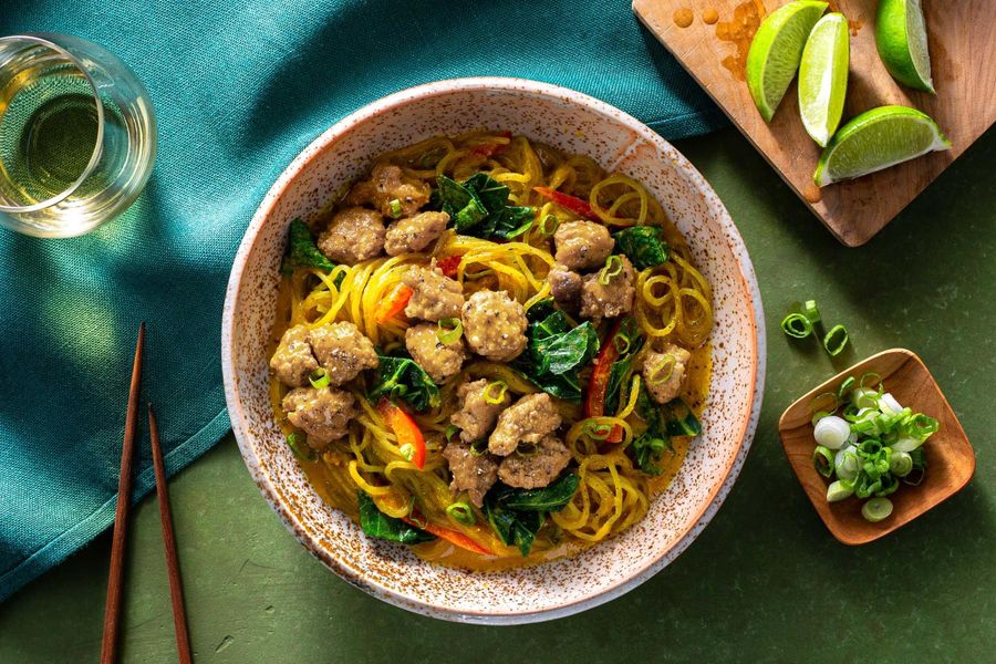 Curry noodle bowls with broccoli leaves and bell pepper