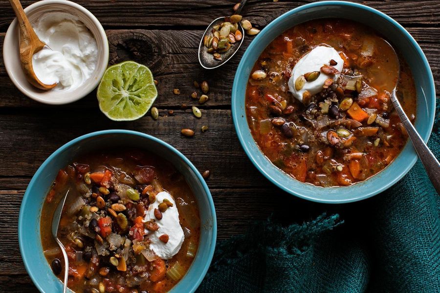 Black bean and quinoa chili with lime, yogurt, and pumpkin seeds