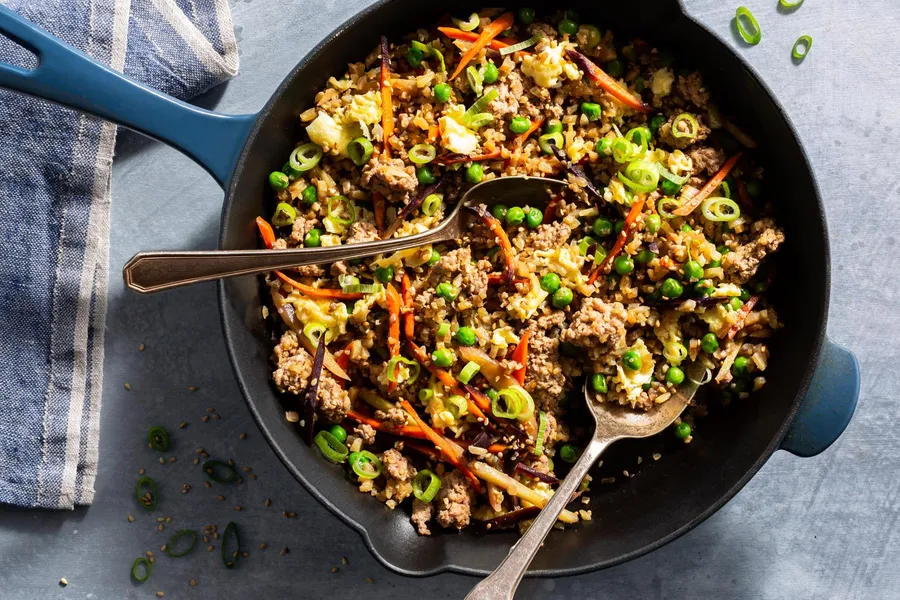 Pork fried cauliflower “rice” with carrots, peas, and scallions