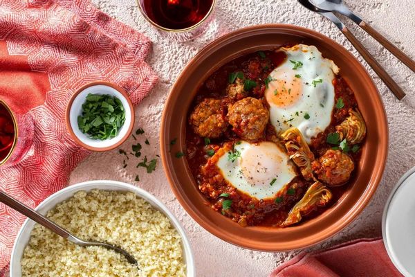 Moroccan lamb tagine with artichokes, tomato-poached eggs, and couscous